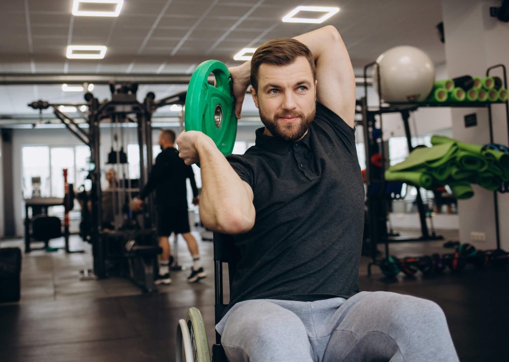 Man in a wheelchair working out with a weight