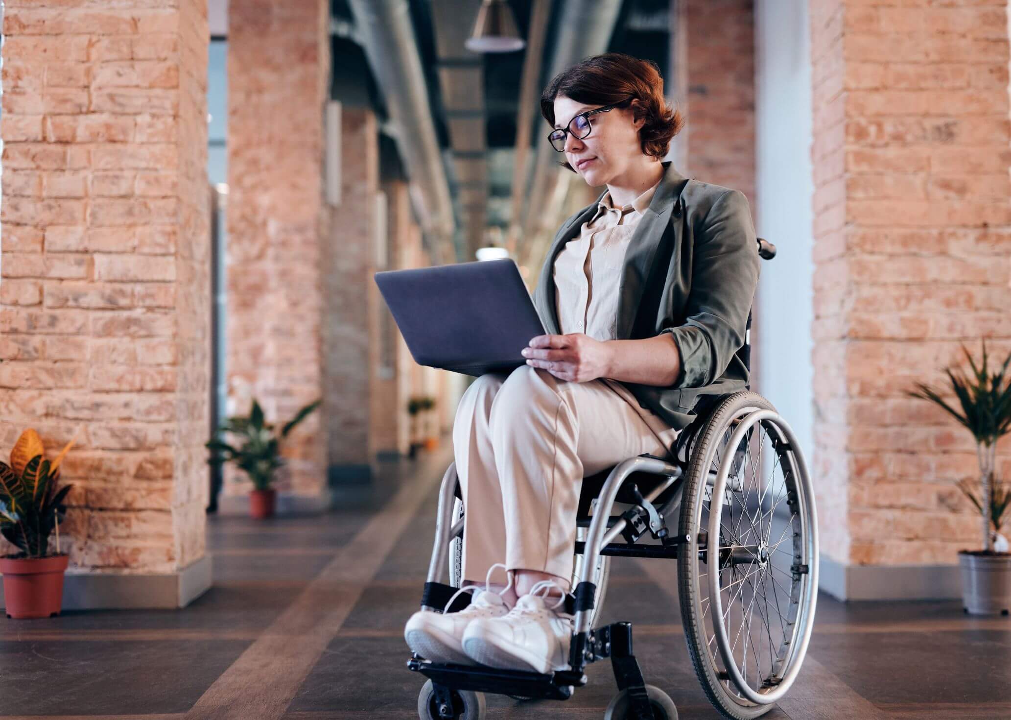 Woman in a wheelchair using a laptop